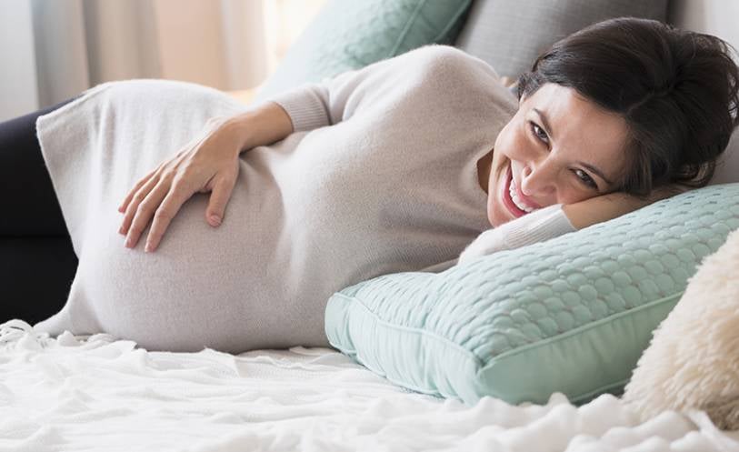 pregnant women on a bed