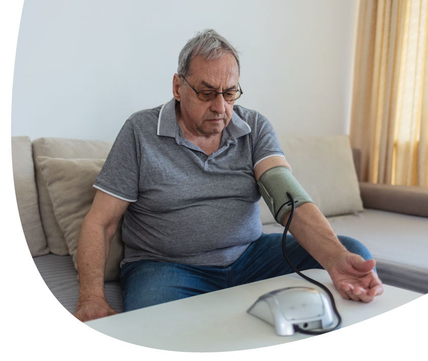 man siting a a coach with a preasure machine