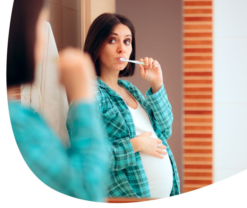 pregnant girl brushing teeth