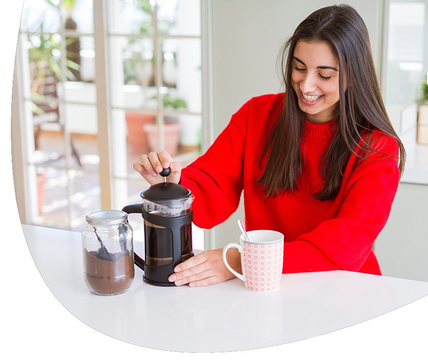 Woman serving coffee on a cup