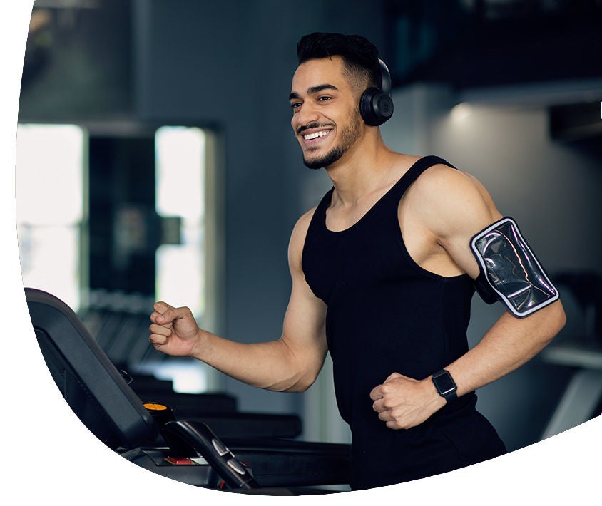 Man running on a running band while listen music 