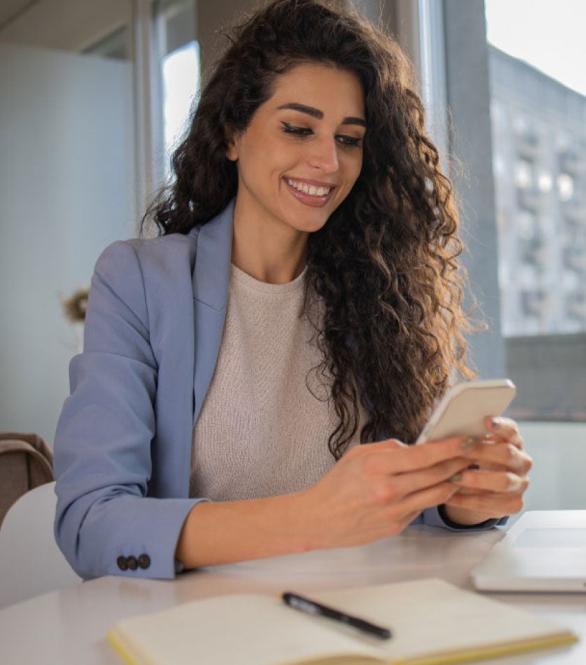 girl with a smarthphone in hands and smiling